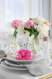 Stylish table setting with beautiful peonies in dining room