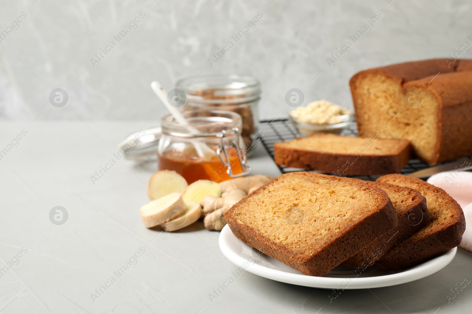 Photo of Fresh gingerbread cake slices served on light table, space for text