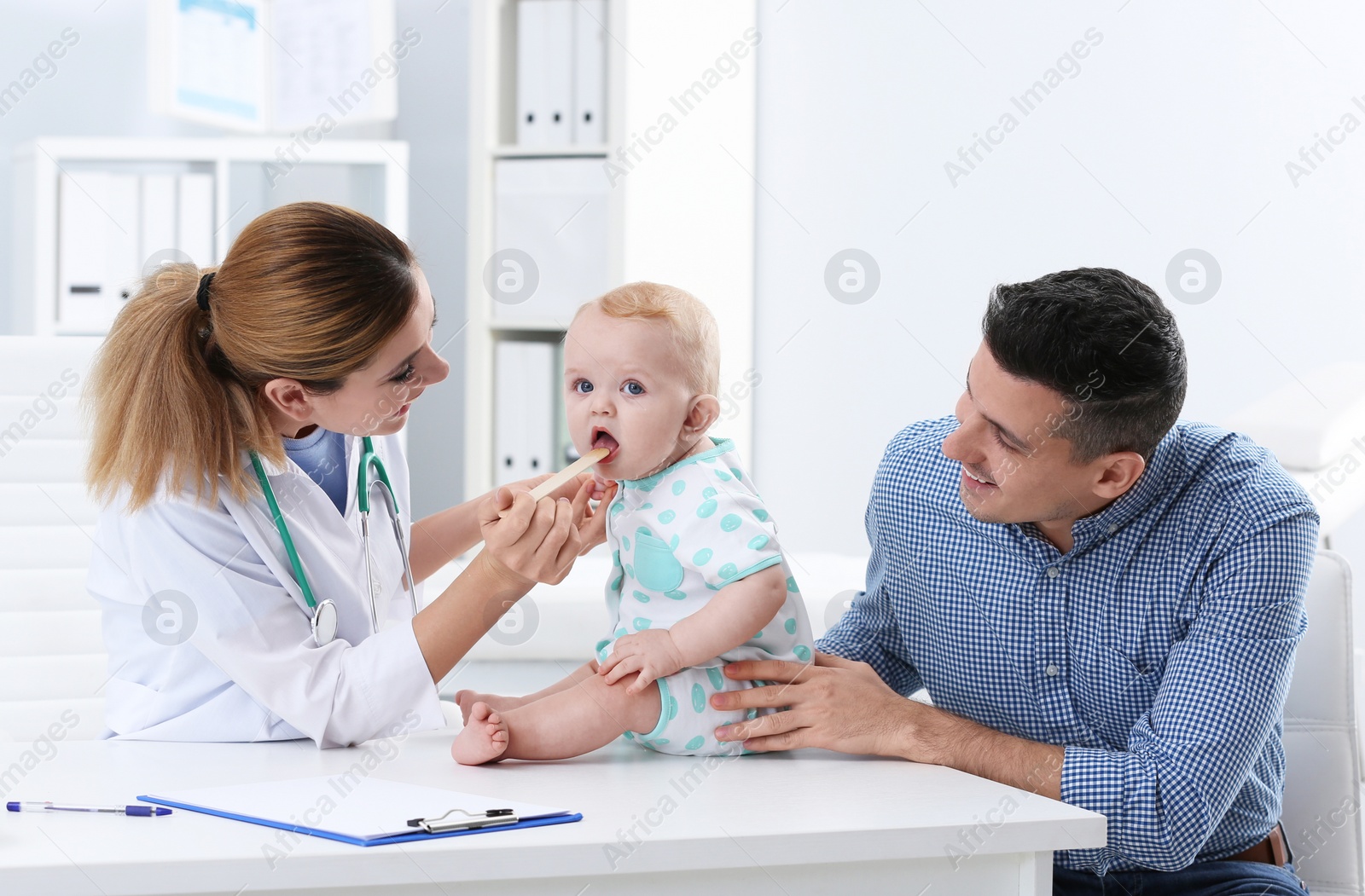 Photo of Man with his baby visiting children's doctor in hospital