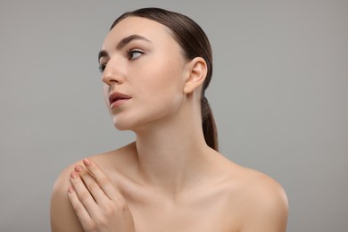 Photo of Portrait of beautiful woman on grey background