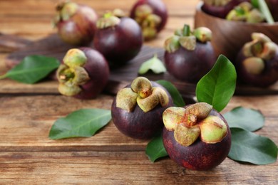 Fresh ripe mangosteen fruits on wooden table