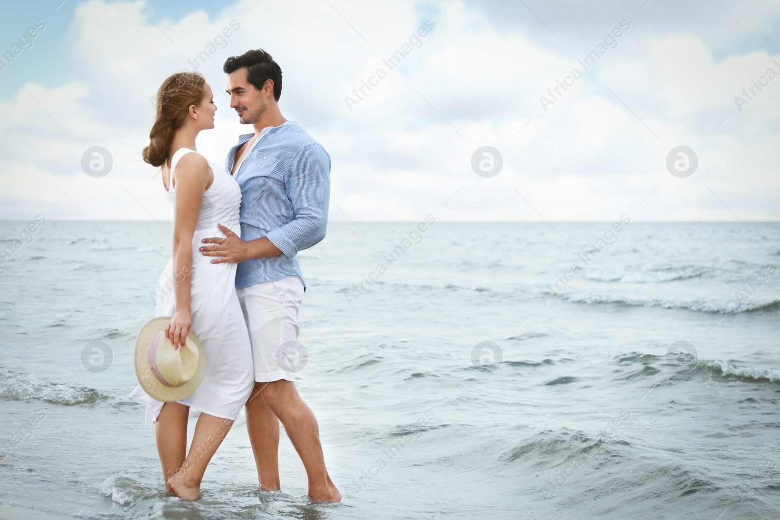 Photo of Happy young couple spending time at sea beach