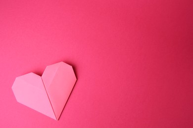 Photo of Paper heart on pink background, top view and space for text. Origami art