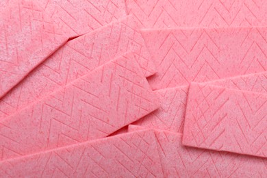 Photo of Sticks of pink chewing gum as background, top view