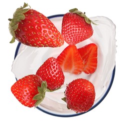 Delicious ripe strawberries falling into bowl with yogurt on white background, top view