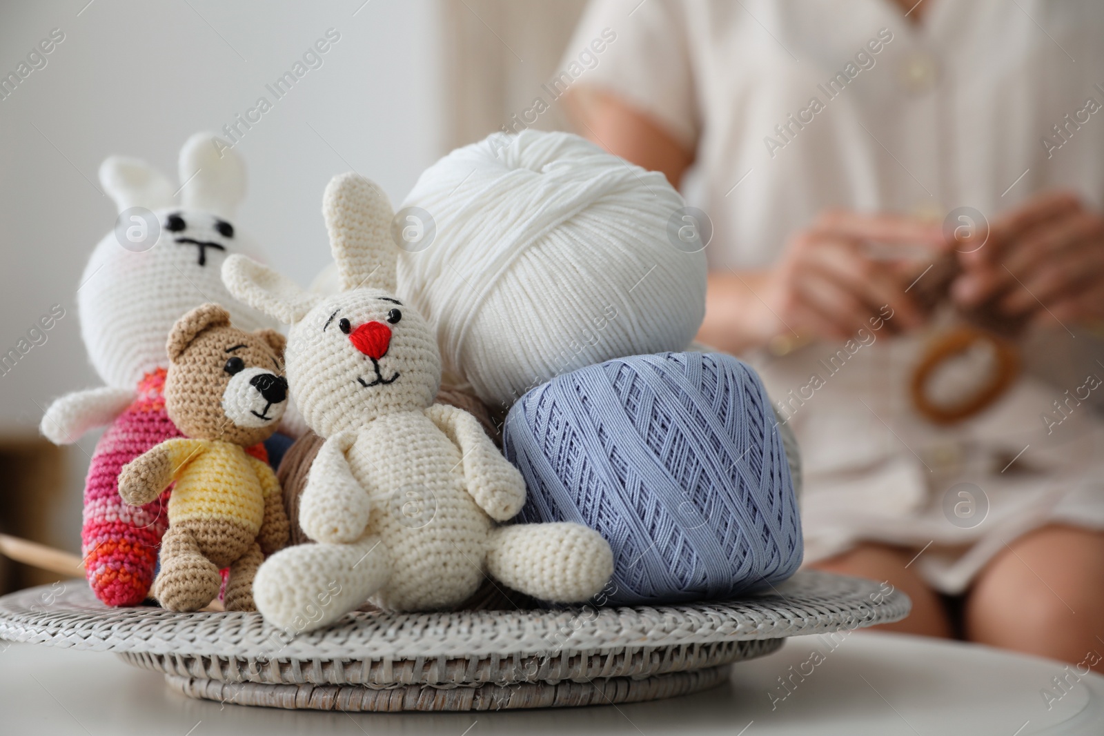 Photo of Crocheted toys and clews on table. Engaging in hobby