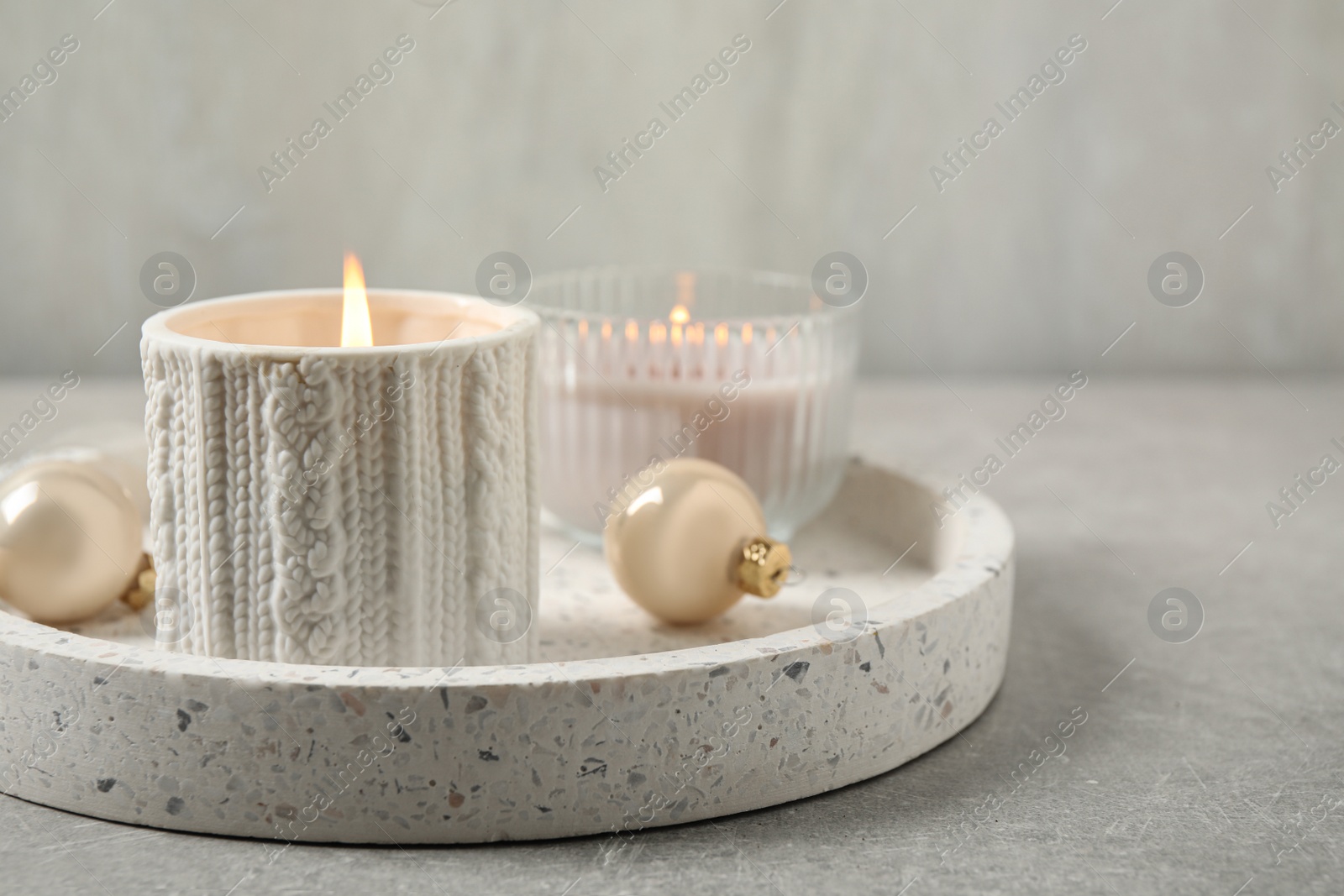 Photo of Tray with candles and Christmas decor on grey table, space for text