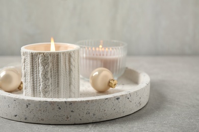 Photo of Tray with candles and Christmas decor on grey table, space for text