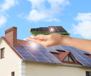 Image of Woman demonstrating solar panel outdoors, closeup. Alternative energy source 