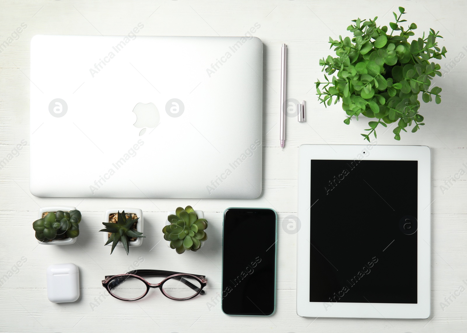 Photo of MYKOLAIV, UKRAINE - JULY 10, 2020: Flat lay composition with Iphone 11, MacBook laptop and IPad tablet on white wooden table