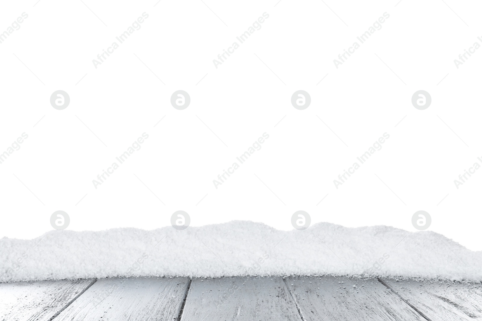 Photo of Heap of snow on grey wooden surface against white background