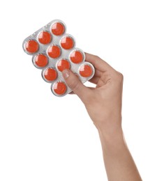 Photo of Woman holding blister with cough drops on white background, closeup