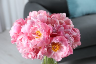 Beautiful bouquet of pink peonies in vase indoors, closeup