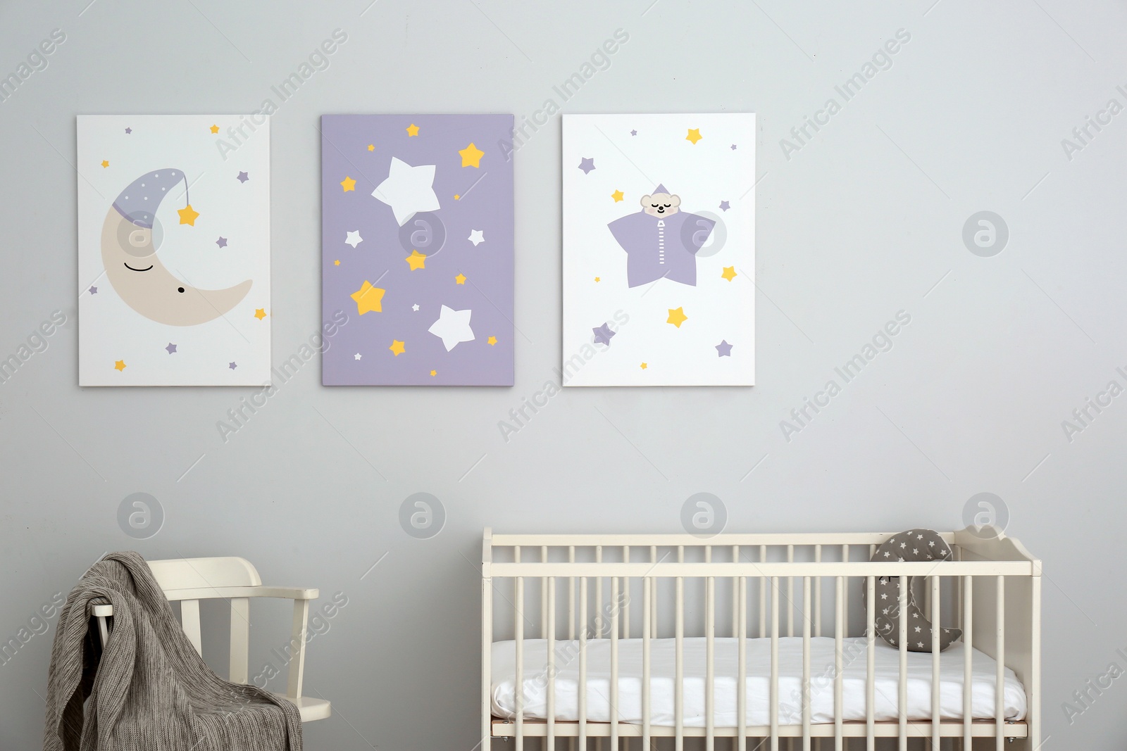 Photo of Baby room interior with crib and cute posters on wall