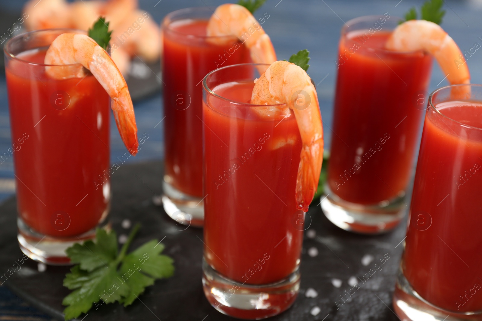 Photo of Shrimp cocktail with tomato sauce served on slate board