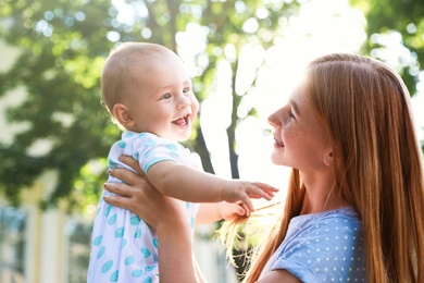 Photo of Teen nanny with cute baby outdoors on sunny day