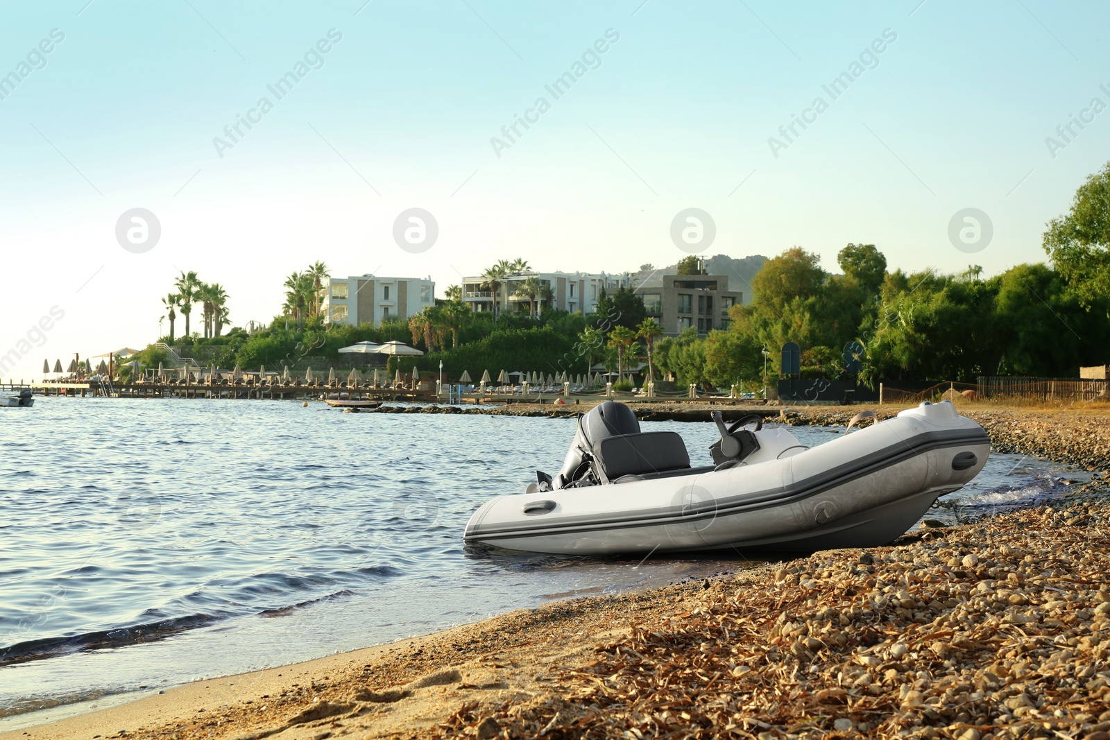 Photo of Beautiful view of resort and moored boat on seashore