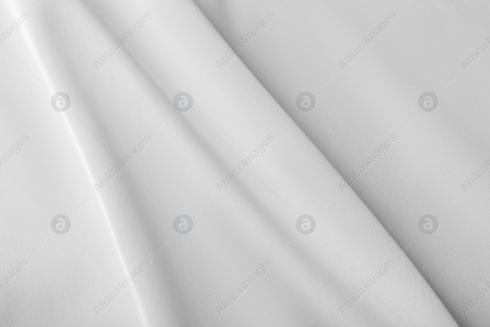 Photo of Texture of white silk ripple fabric as background, top view