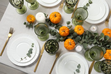 Photo of Beautiful autumn table setting. Plates, cutlery, glasses, pumpkins and floral decor, flat lay