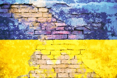 National flag of Ukraine painted on old brick wall