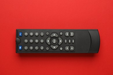 Photo of Remote control on red background, top view