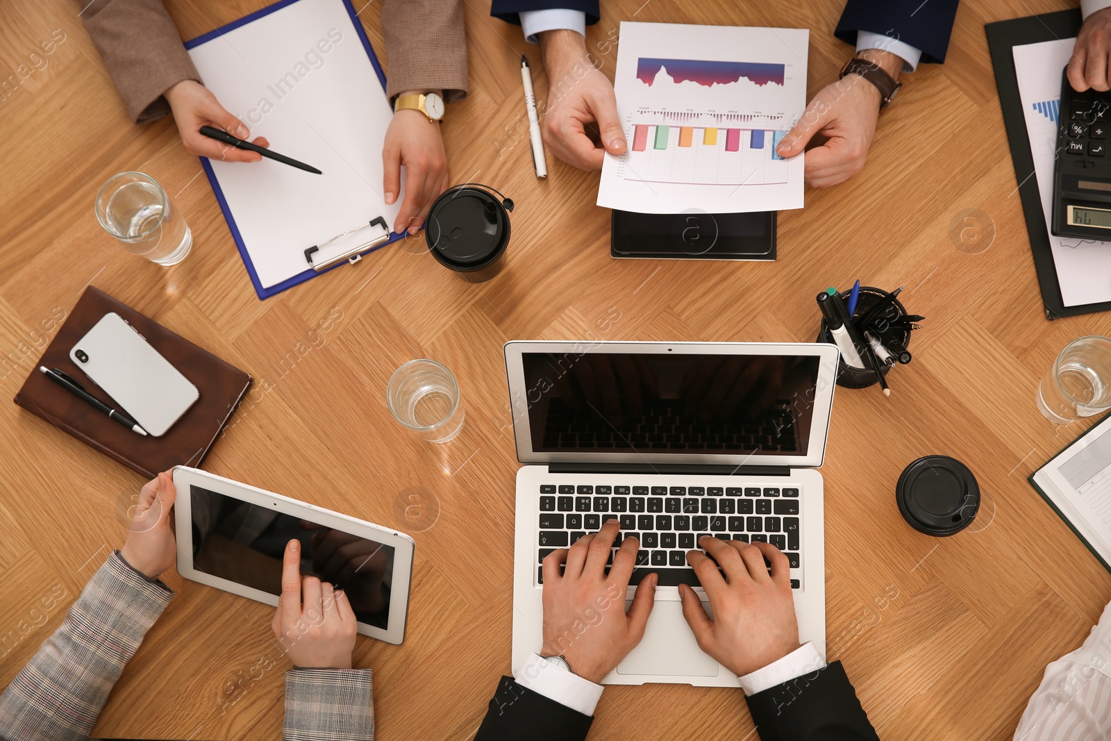 Photo of Businesspeople having meeting at table, top view. Management consulting