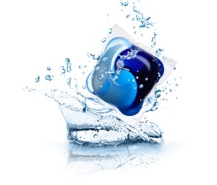 Image of Laundry capsule and splashing water on white background. Detergent pod
