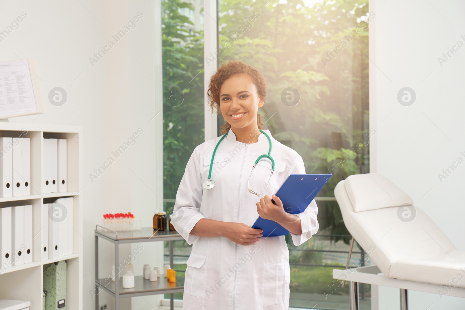 Photo of Portrait of African American doctor in coat at workplace