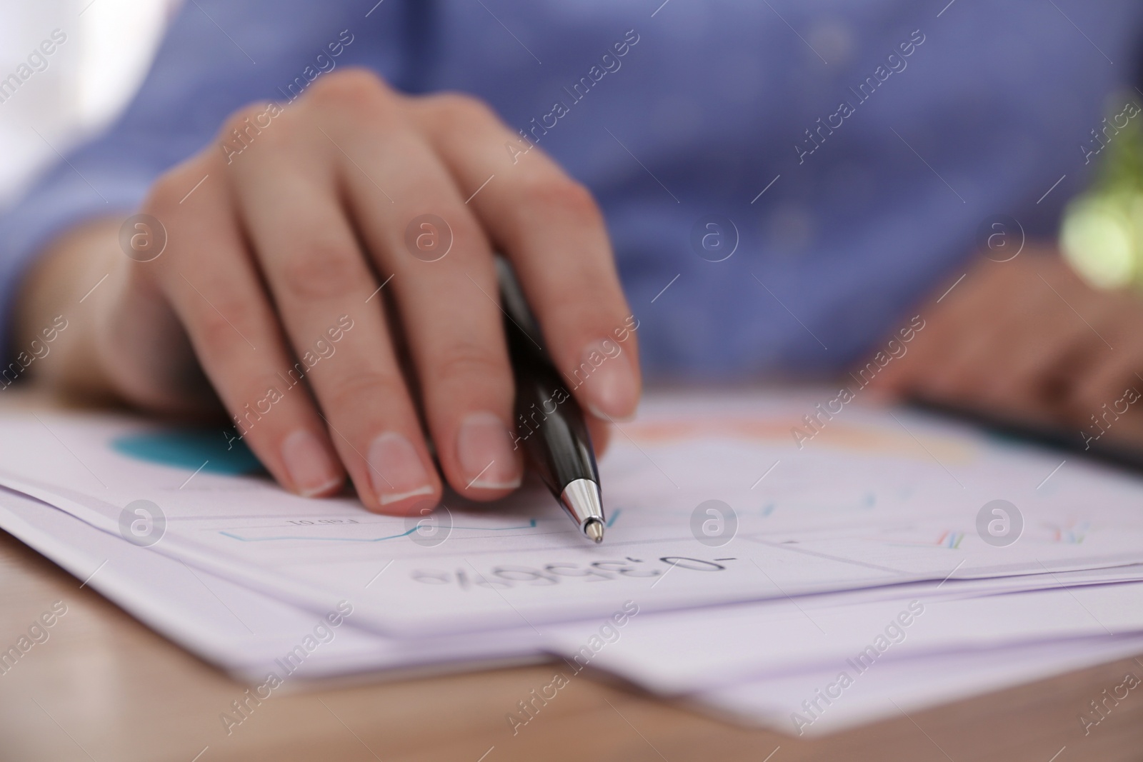 Photo of Businesswoman working with documents at table in office, closeup. Investment analysis