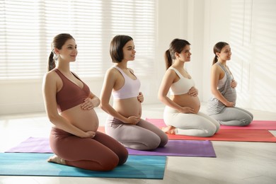 Photo of Group of pregnant women practicing yoga in gym