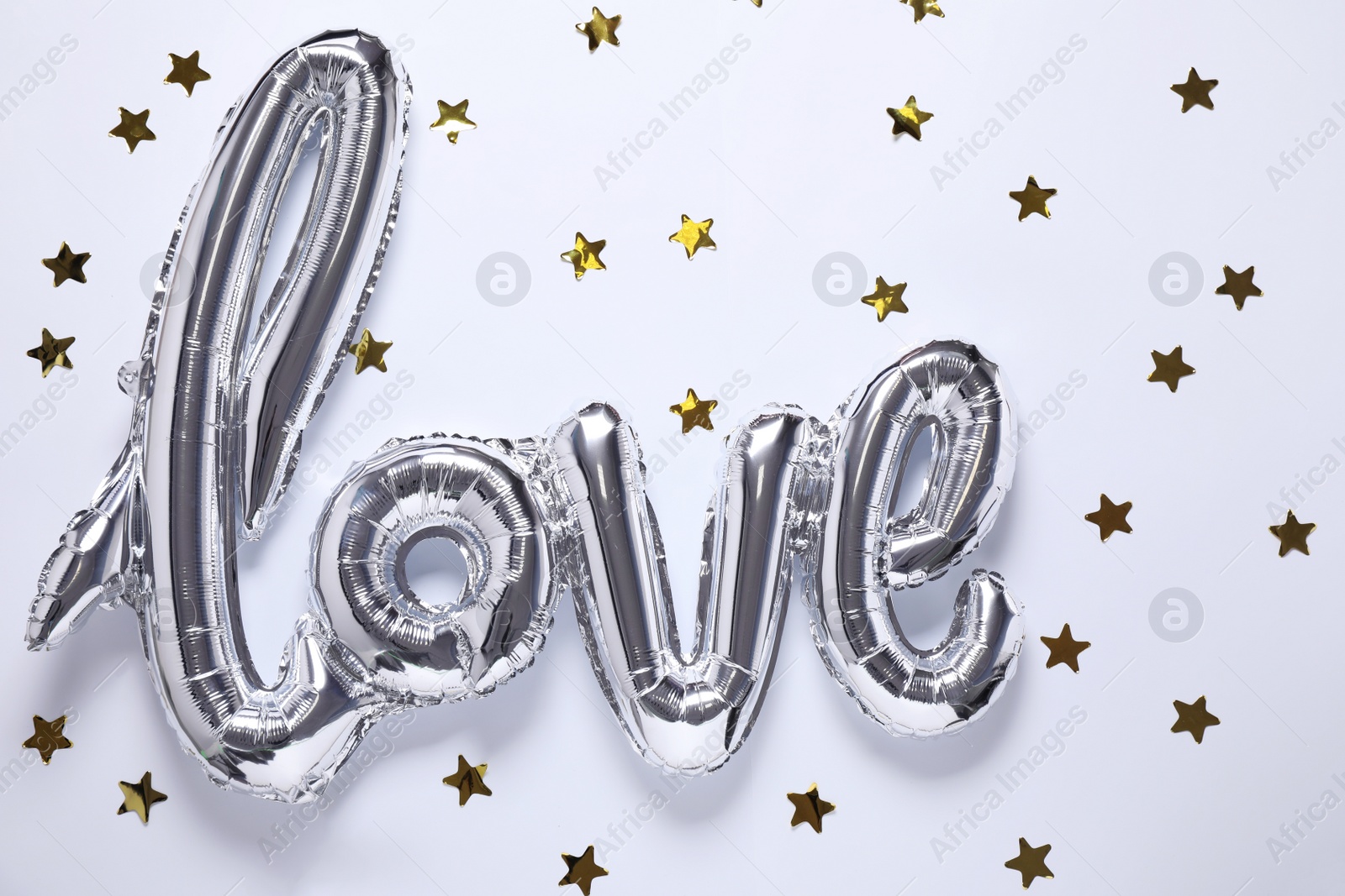 Photo of Silver balloon in shape of word LOVE on white background, top view