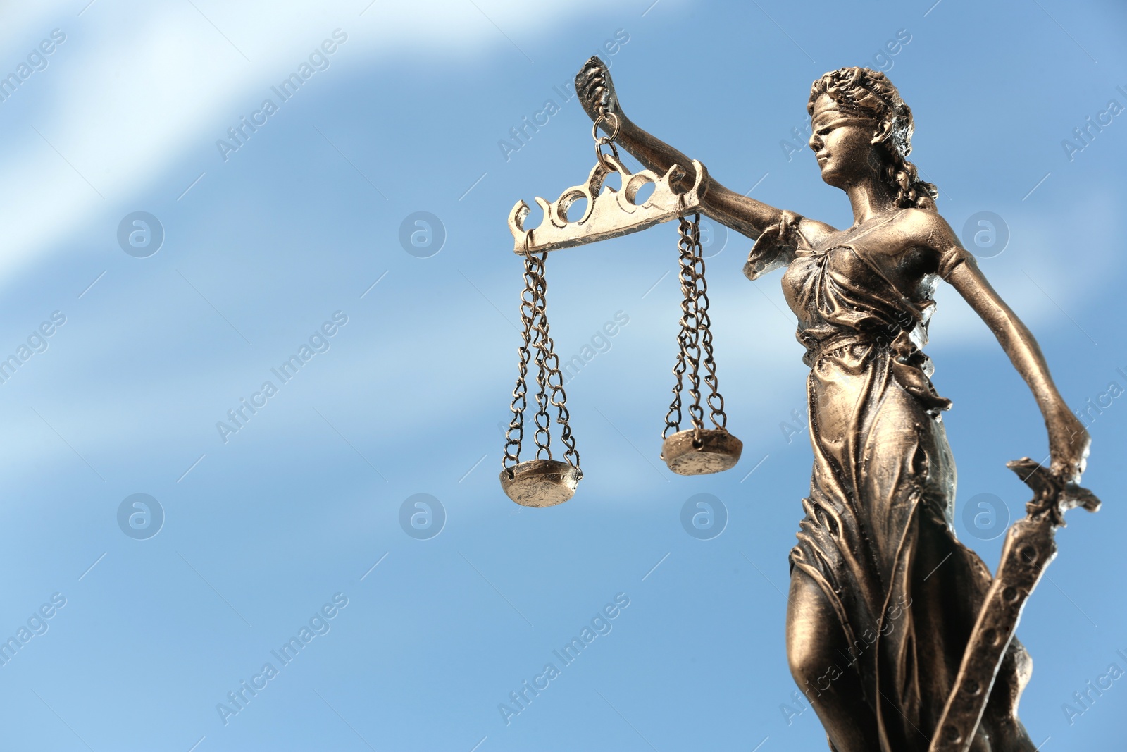 Photo of Symbol of fair treatment under law. Figure of Lady Justice against sky, closeup with space for text