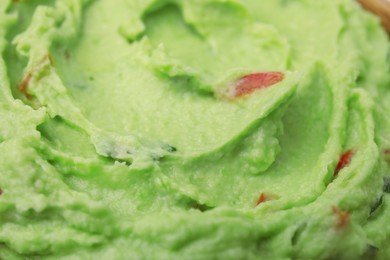 Photo of Delicious guacamole sauce as background, closeup view