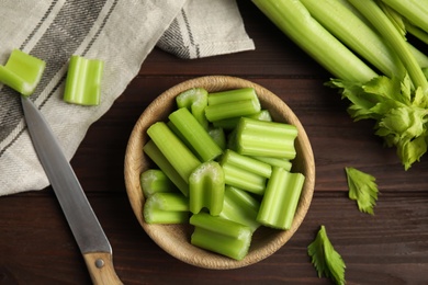 Fresh ripe green celery on wooden table, flat lay