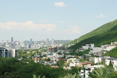 Picturesque view of city and green mountains