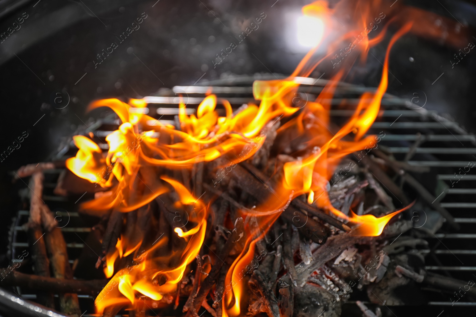 Photo of New modern barbecue grill with coals, closeup