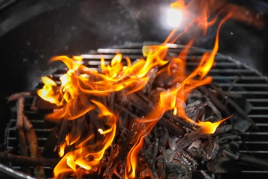 Photo of New modern barbecue grill with coals, closeup