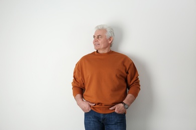 Portrait of handsome mature man on light background