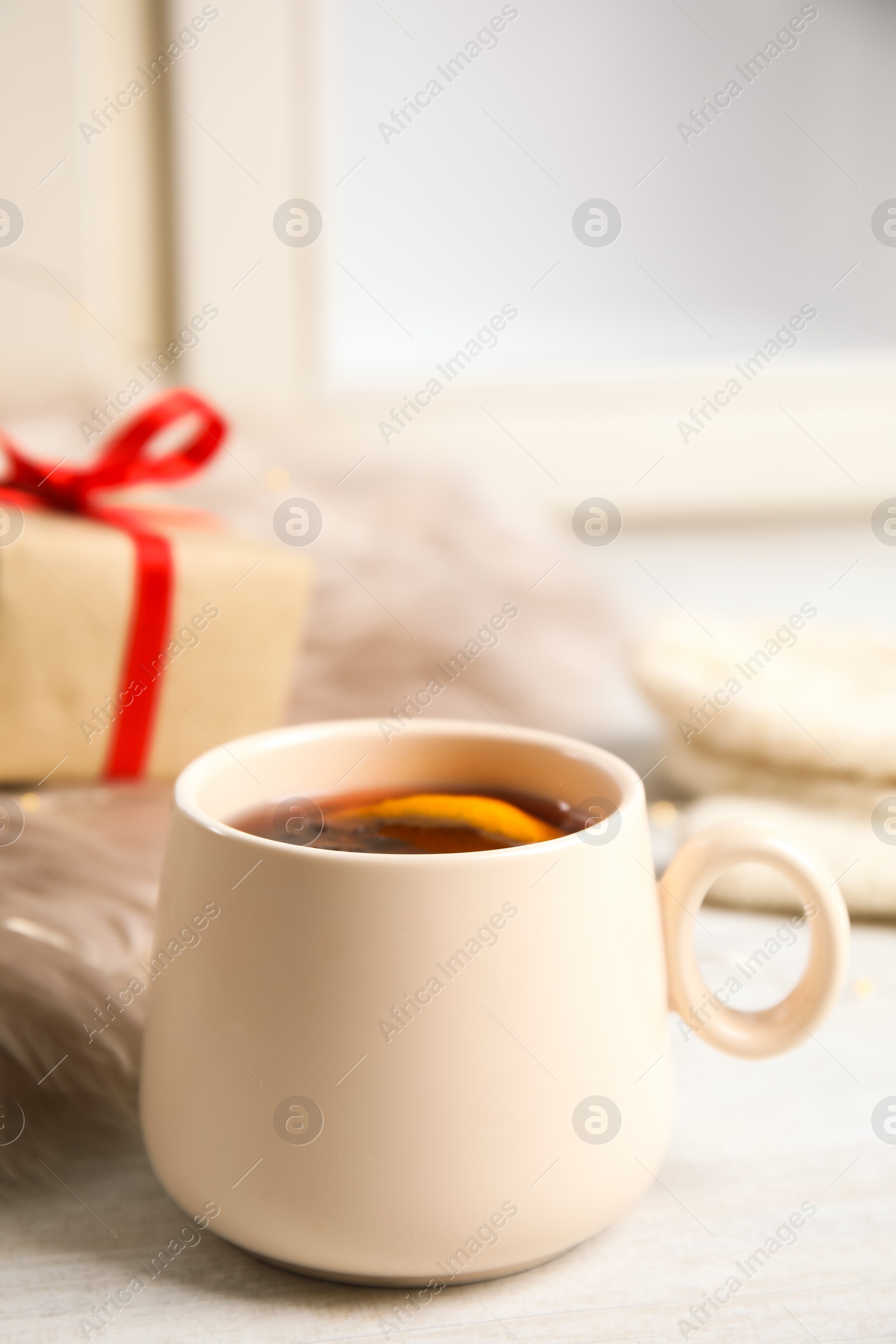 Photo of Cup of hot mulled wine on window sill. Winter drink