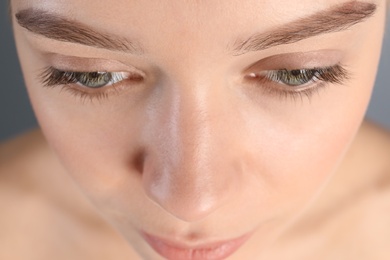 Photo of Young woman with beautiful natural eyelashes, closeup