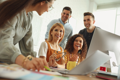 Photo of Team of professional designers working in office