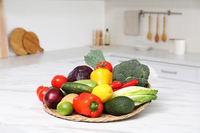 Pile of fresh ripe vegetables and fruits on table in kitchen