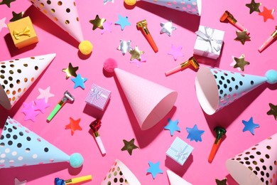 Flat lay composition with party hats on pink background