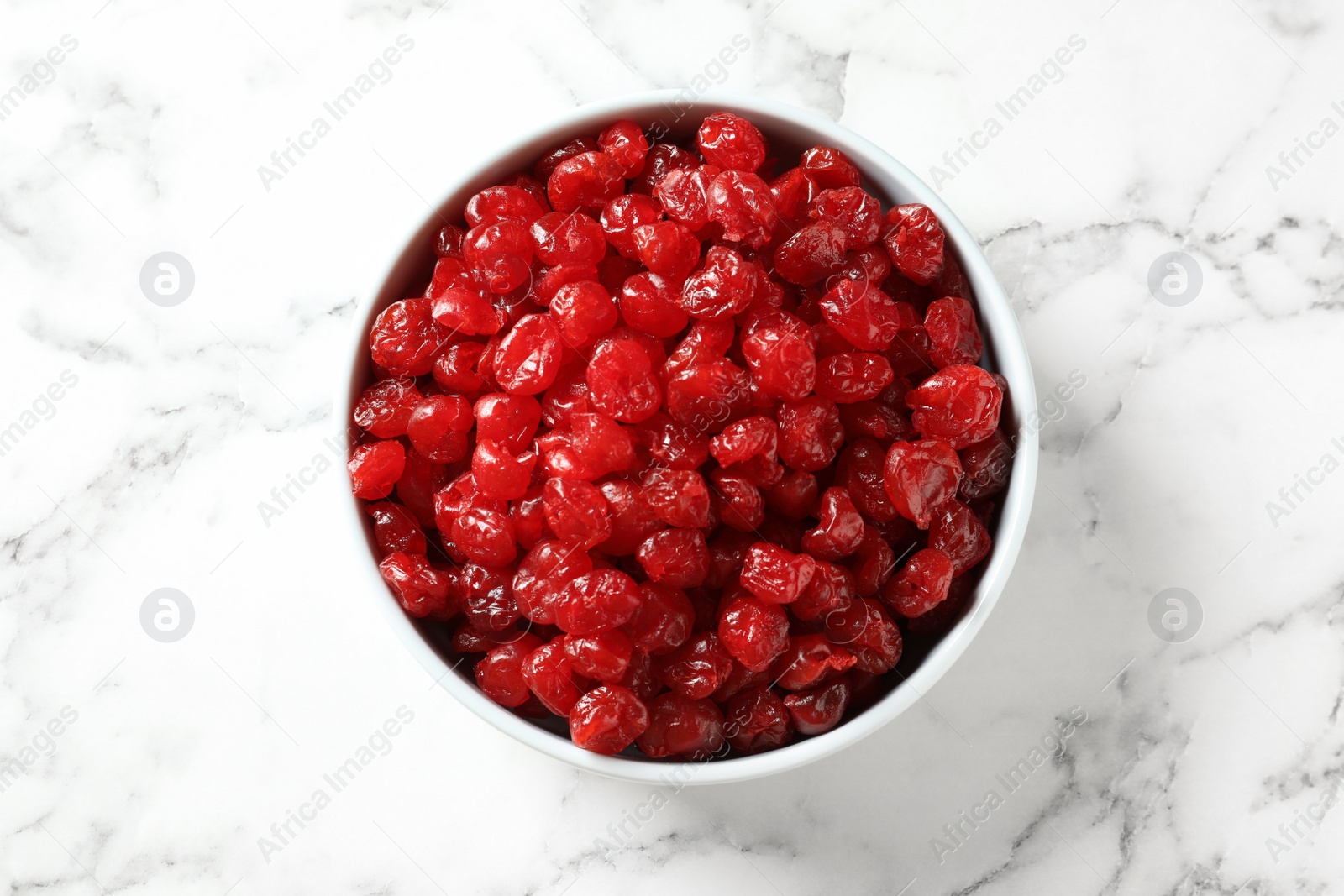 Photo of Bowl of sweet cherries on marble background, top view. Dried fruit as healthy snack