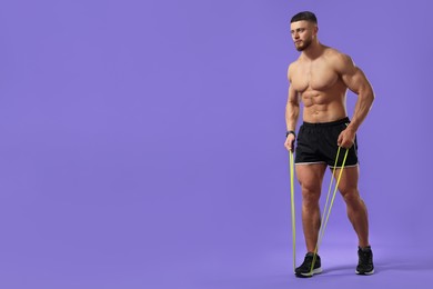 Photo of Muscular man exercising with elastic resistance band on purple background. Space for text
