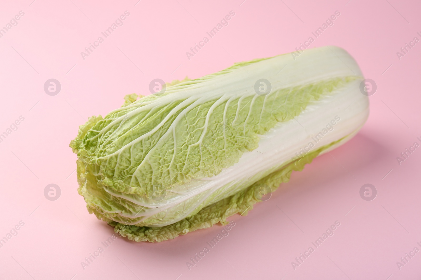 Photo of Fresh ripe Chinese cabbage on pink background