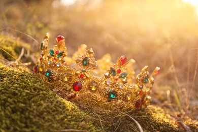 Photo of Beautiful golden crown on grass outdoors. Fantasy item