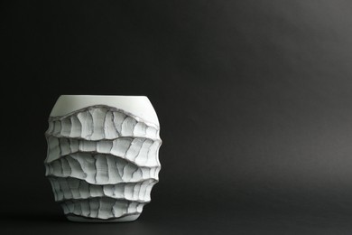 Photo of Stylish empty ceramic vase on black background, space for text
