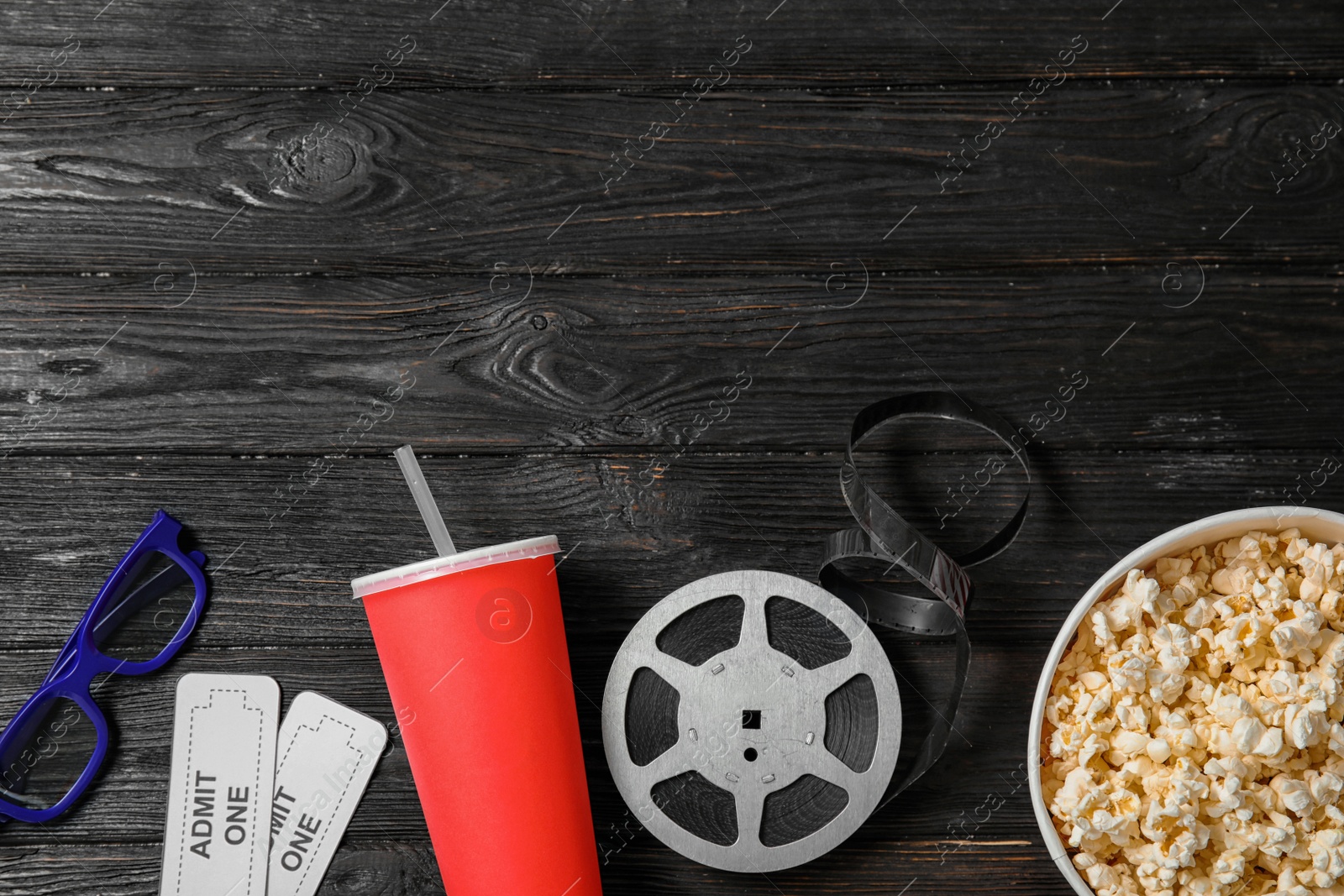 Photo of Flat lay composition with tickets, popcorn and space for text on wooden background. Cinema snack