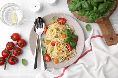 Delicious pasta primavera served on white table, flat lay